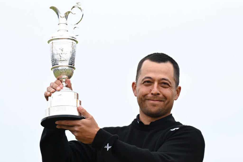 Xander Schauffele poses with the Claret Jug after winning The Open at Royal Troon in 2024